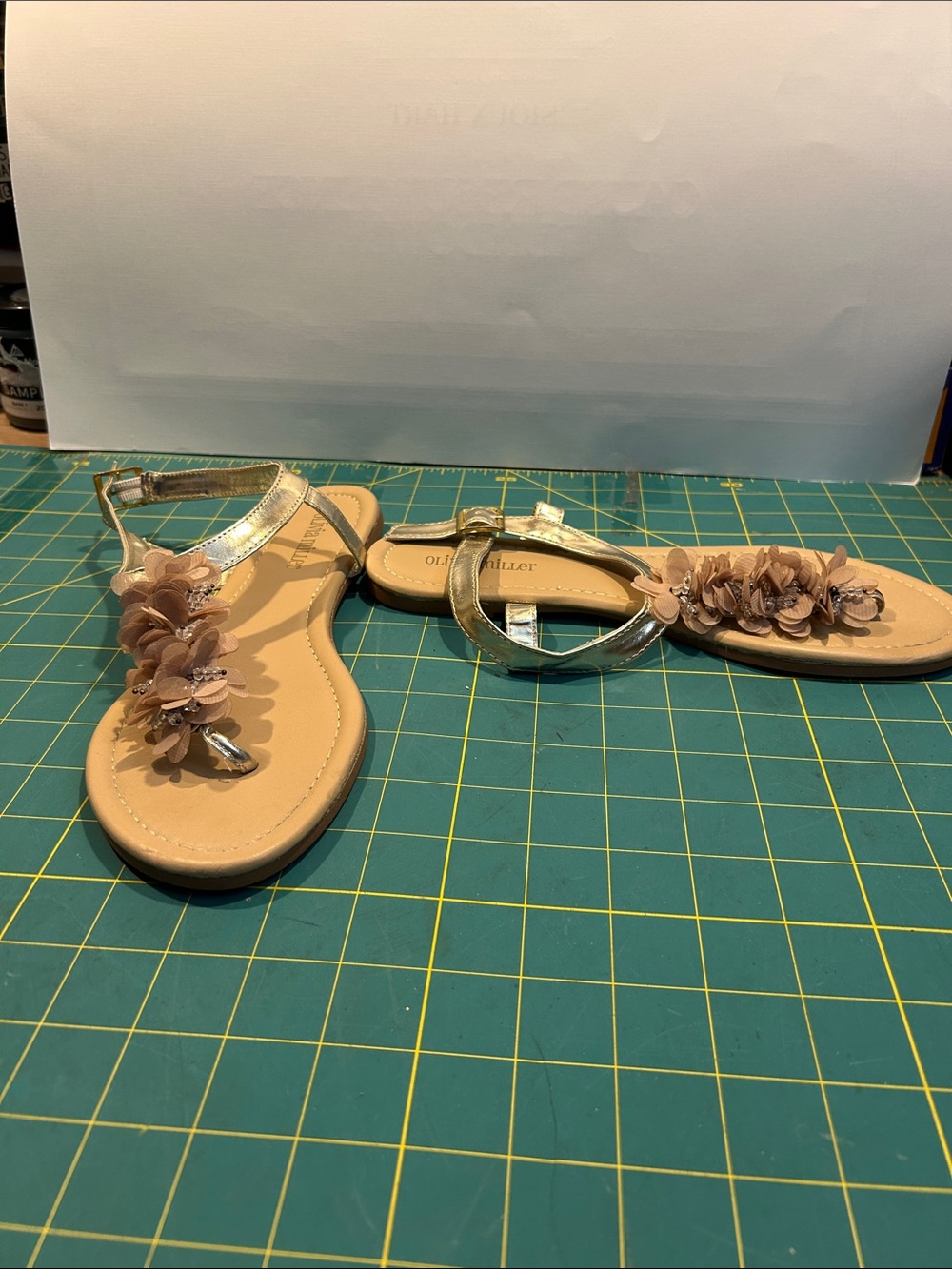 Olivia Miller Gold T-Strap Sandals with Beige Floral Accents